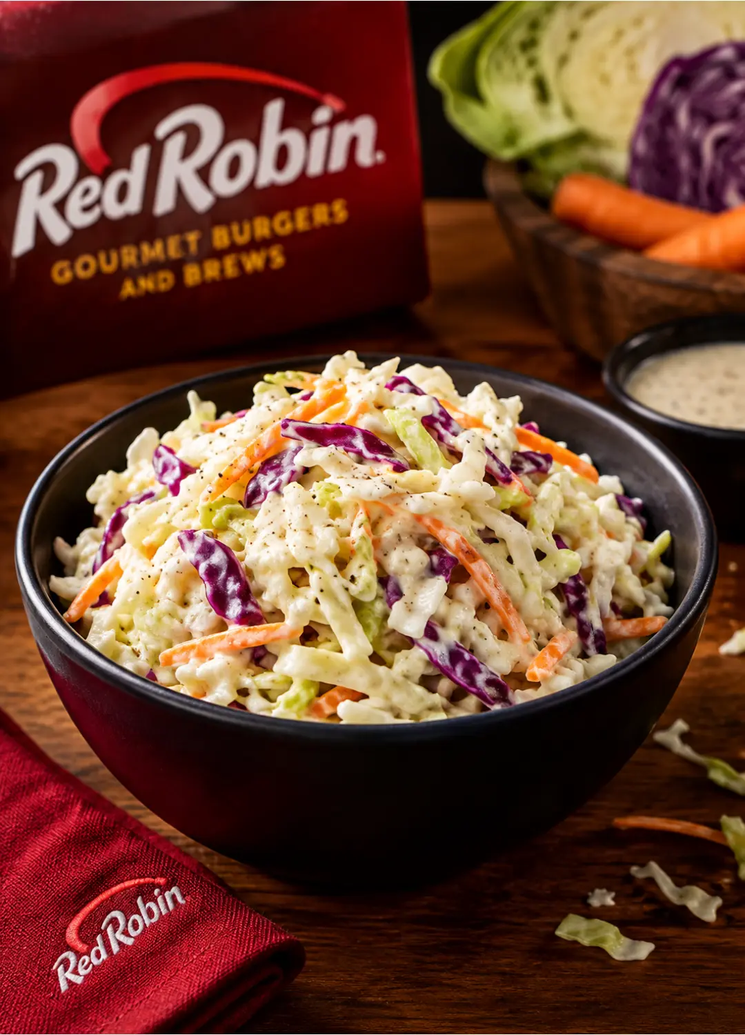 Red Robin coleslaw served in a bowl next to a gourmet burger